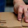 Skilled worker inspecting packaging box